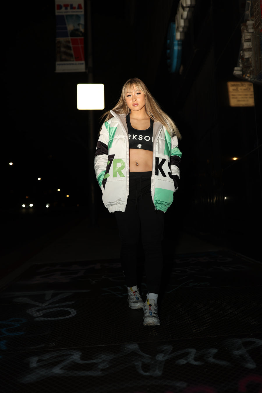 CVY athlete in a CRKSOLY. jacket on a Los Angeles street at night