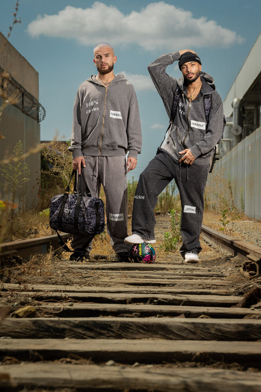 Two CVY athletes in matching sets on railway tracks in Los Angeles